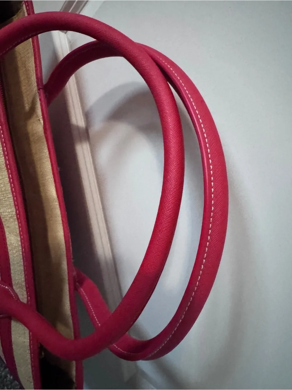 Tory Burch straw tote features vibrant red leather stripes